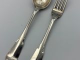 pair of silver plated spoons and a fork on a table
