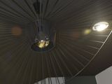 a large black umbrella hanging from the ceiling in a room