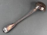 silver spoon on a gray surface with a spoon in the middle of it