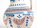 a blue and white vase sitting on a white surface
