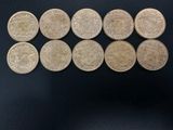 six different types of coins are arranged on a black surface