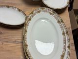 many plates and bowls sitting on a wooden table