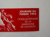 a picture of a red and white sign on a white wall