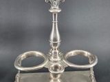 silver plated candle holder with two candles on a stand