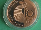 a close up of a coin in a plastic container on a green surface