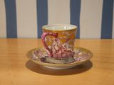 a cup and saucer sitting on a wooden table