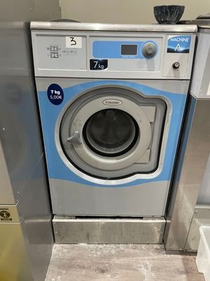 an image of a washing machine in a public bathroom