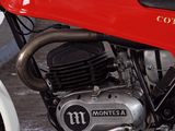 a red motorcycle that is parked in a garage