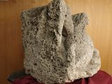 a large rock sitting on top of a red table cloth