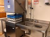 a kitchen with a sink and a refrigerator in it