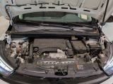 a car with its hood open and the engine in the trunk