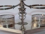 a silver tray with two candles and a candle holder