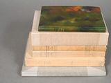 three books stacked on top of each other on a table
