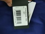 a person that is holding a tag with a barcode on it