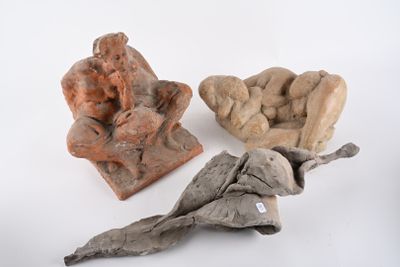 three pieces of pottery sitting on a white surface