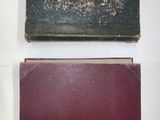 two old books sitting on top of a table next to each other