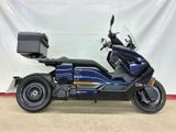 the blue motorcycle is parked in front of a white backdrop