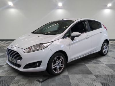 the white ford fiesta is parked in a room with a checkered floor