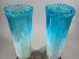 pair of blue glass vases with gold bases on a white background