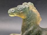 a glass horse that is standing on its hind legs