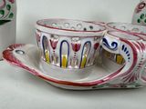 two cups and a saucer sitting on a table