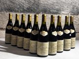 bottles of wine lined up in a row on a table