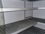 a metal shelf in the middle of a room