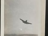 a black and white photo of an airplane flying in the sky