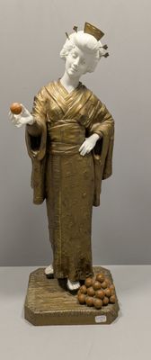 une statue représentant une femme tenant une pomme à la main