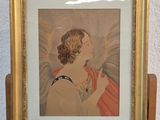 painting of an angel in a gold frame on a wooden easel