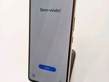 a close up of a cell phone on a stand on a white surface