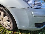 a close up of a car ' s front bumper and tire on the grass