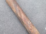an old baseball bat laying on top of a cement floor
