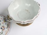 a white bowl and a bowl with a lid on a table