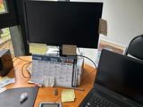 a desk with a laptop and a calculator on it