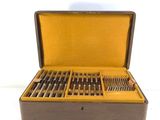 a wooden box with silverware in it on a white surface