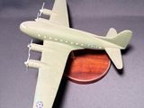 a small model of a plane on a wooden stand