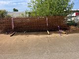 a fence that has been placed on the side of the road