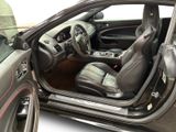 the interior of a car with the door open and the driver ' s seat up