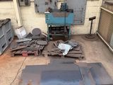 many pieces of metal sitting on the floor in the garage