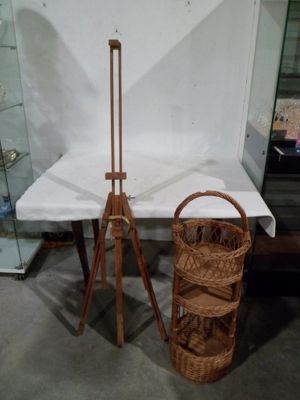 a basket that is sitting next to a wooden easel
