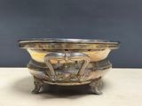 a metal bowl that is sitting on a table