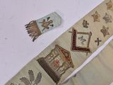 two ties with different designs on them on a table