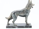 statue of a dog on a marble base on a white background