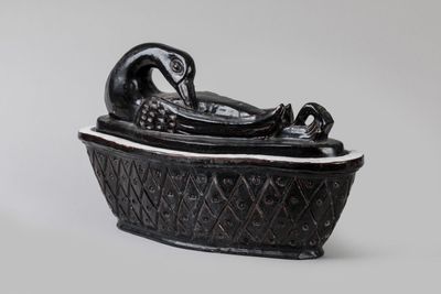 an image of a black and white sculpture of a bird in a bowl