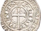 an old silver coin with a cross on it