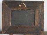 a wooden frame with a chalk board attached to it