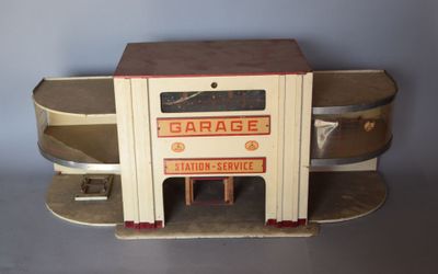a small toy car with a garage on top of it
