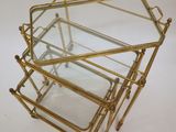 a set of three brass and glass nesting tables