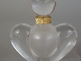 a glass figurine with a gold ring on top of it